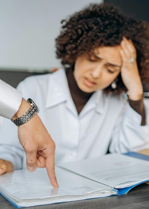 Portrait of a stressed woman employee with afro hair facing work pressure.